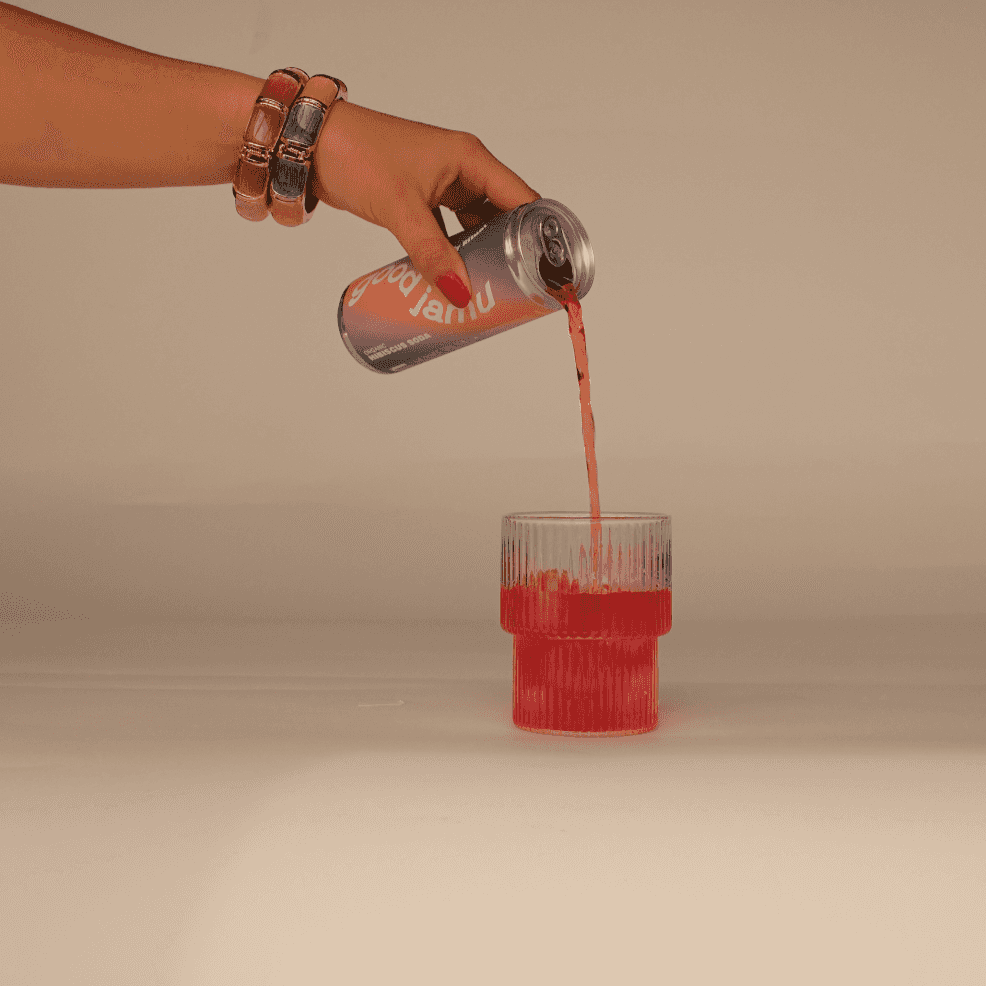 Hibiscus Bio Soda wordt in glas geschonken, roze kleur benadrukt natuurlijke ingrediënten zoals hibiscus en citroenmelisse.